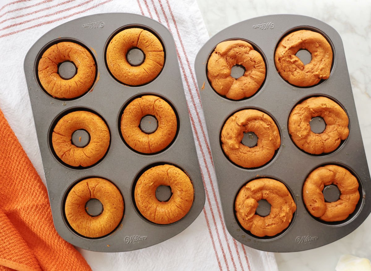 Baked pumpkin donuts still in the donut tin, fresh out of the oven