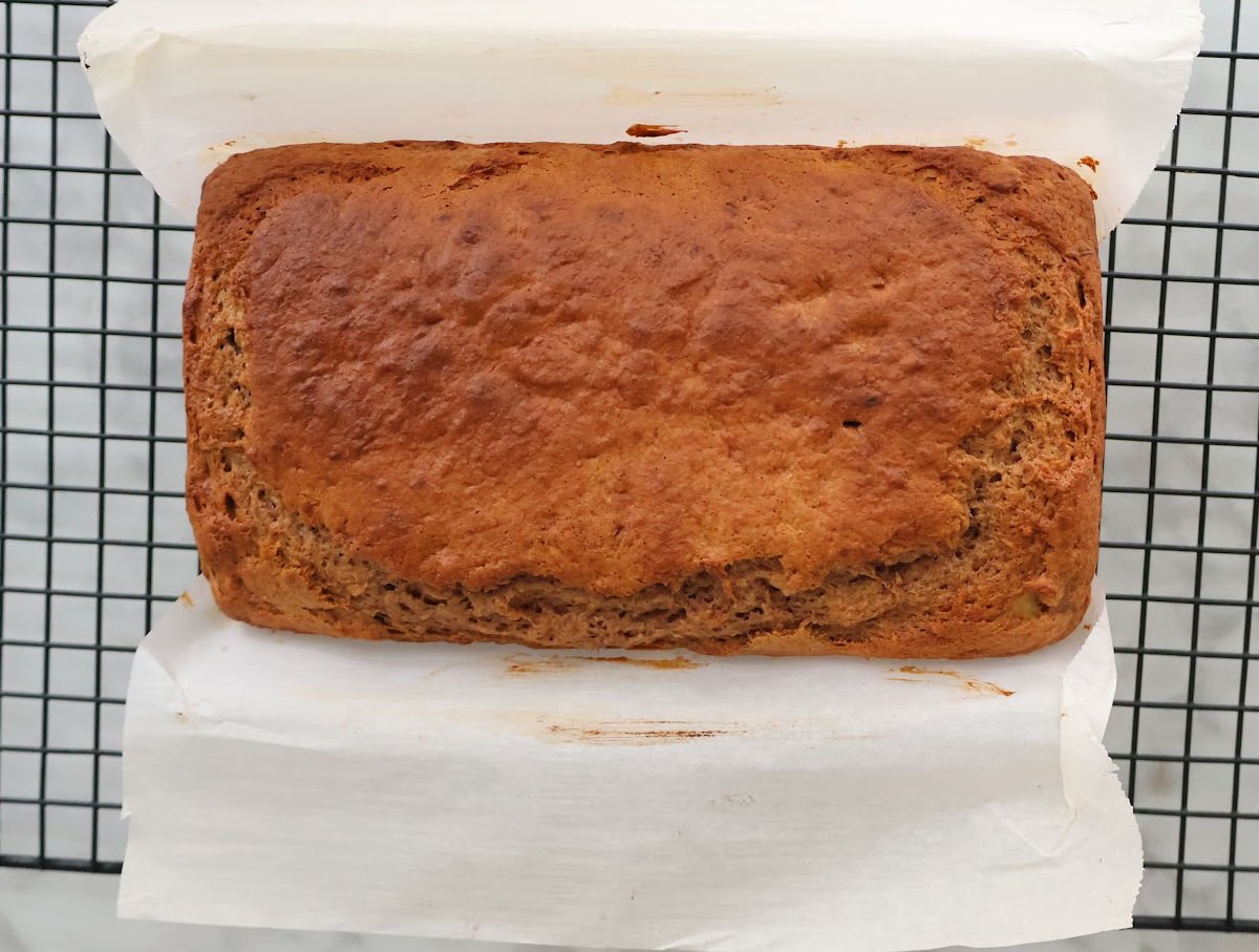 3 ingredient banana bread pulled out of the bread pan cooling on the cooling rack.