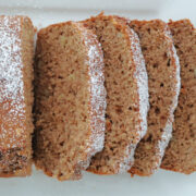3 ingredient spice cake banana loaf sliced with some sprinkled powder sugar on top.