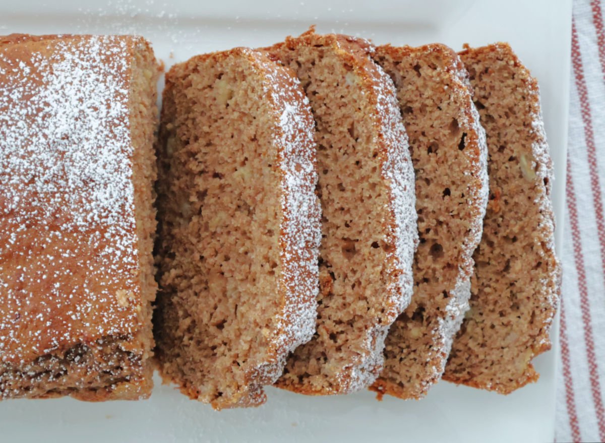 3 ingredient spice cake banana loaf sliced with some sprinkled powder sugar on top.
