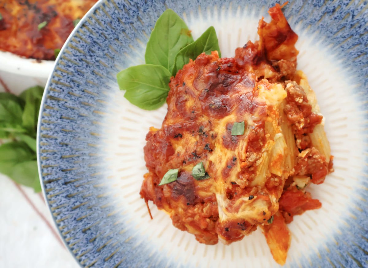 Close-up of cheesy baked pasta with sausage and mozzarella