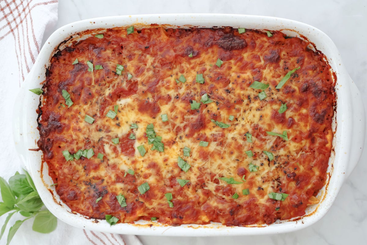 Baked ziti with a sprinkle of fresh basil for garnish.