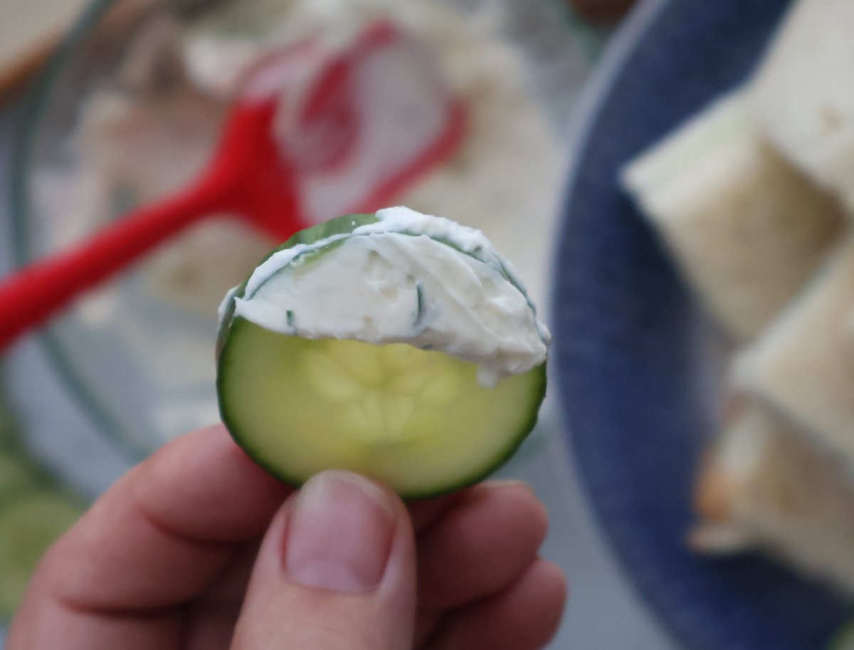a cucumber slice with the cream cheese and ranch spread for the cucumber sandwiches.
