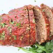 Sliced stovetop stuffing meatloaf on a platter, topped with a glossy ketchup glaze.