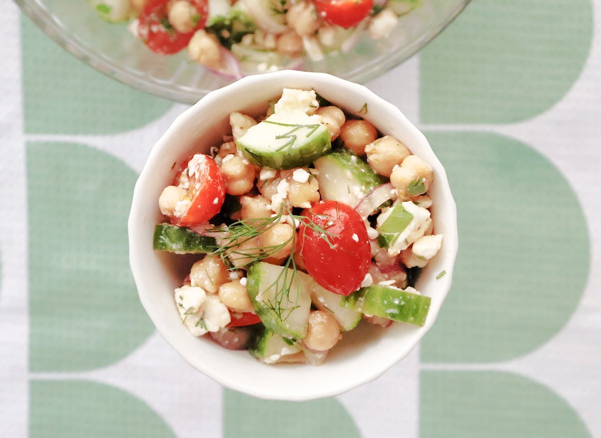 Overhead shot of cucumber chickpea salad served in a shallow bowl