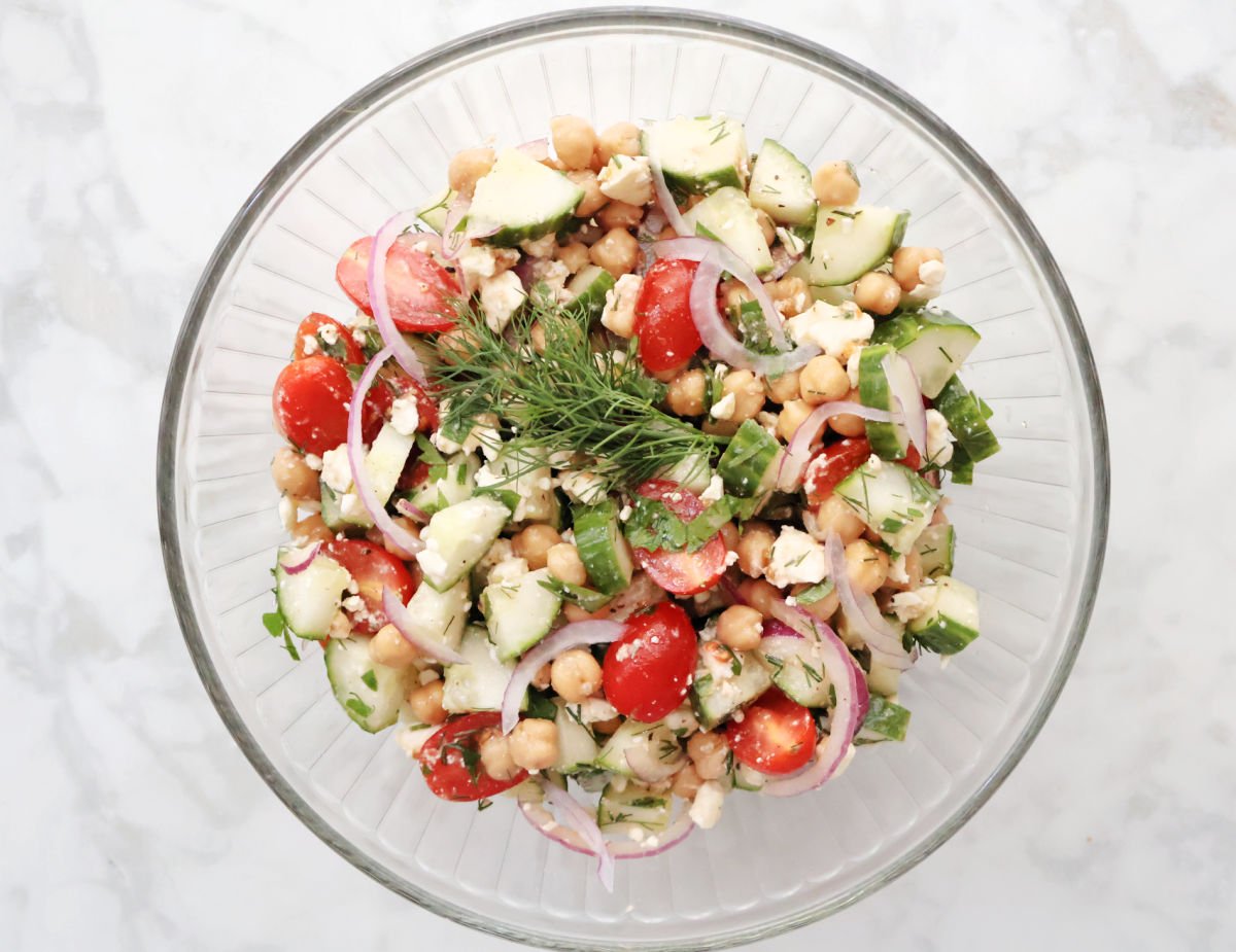 Close-up of finished cucumber chickpea salad with feta and herbs