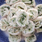 Cream cheese and cucumber tortilla roll ups garnished with chopped dill