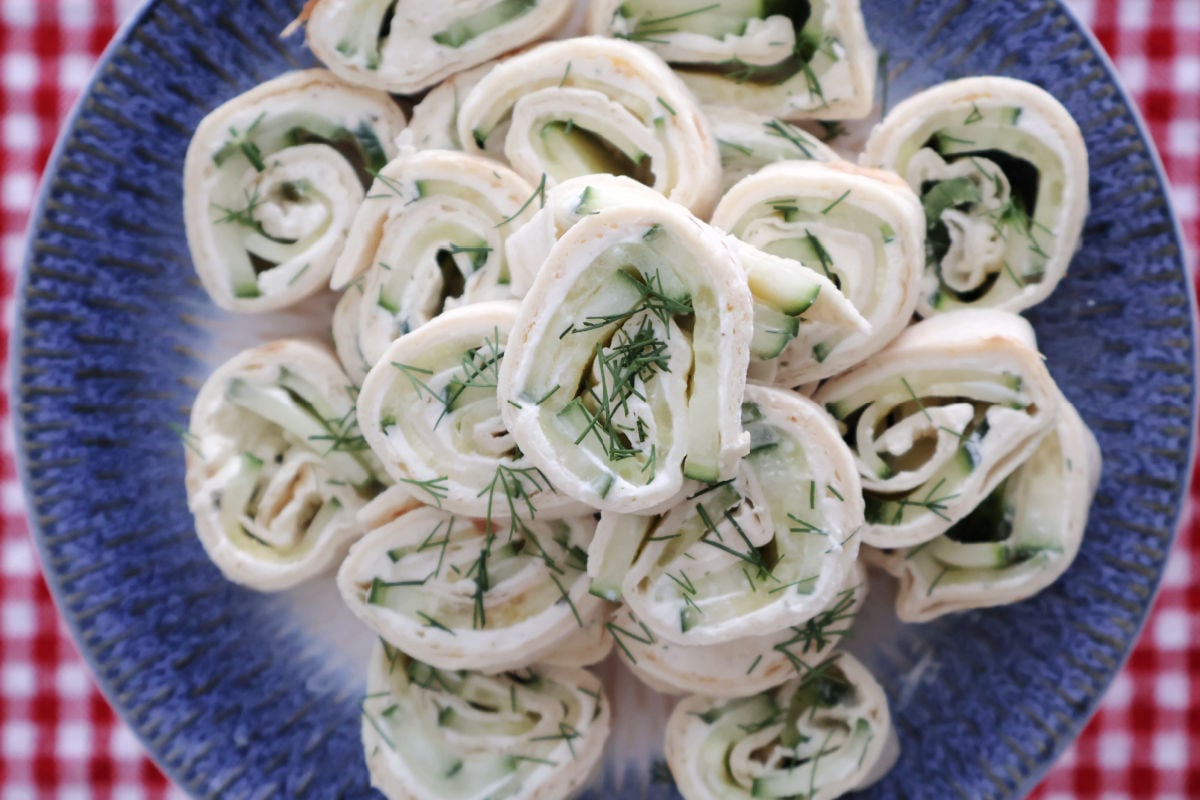 Cream cheese and cucumber tortilla roll ups garnished with chopped dill