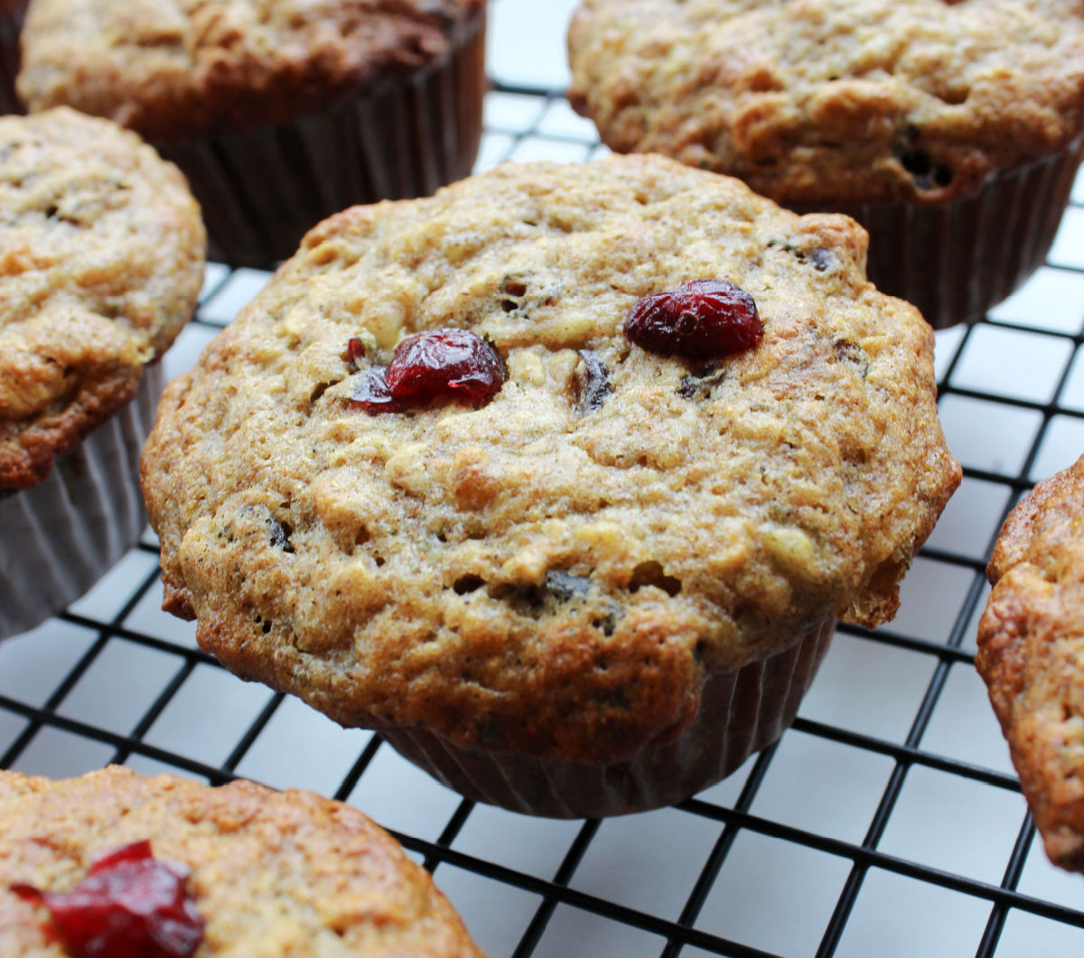 banana cranberry breakfast muffins sitting on a cooling rack.