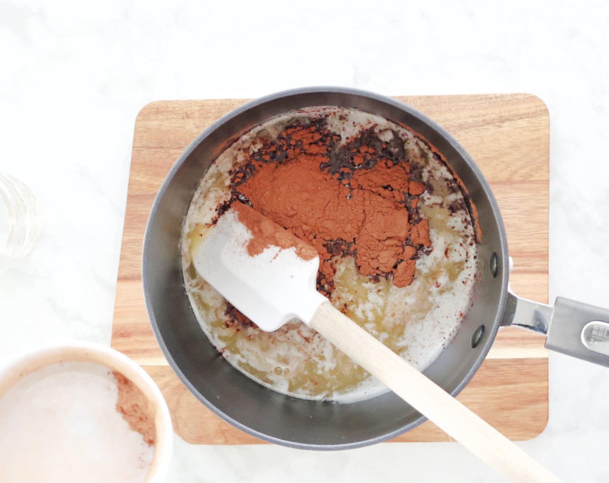 Adding cocoa to melted butter for the boiled icing.