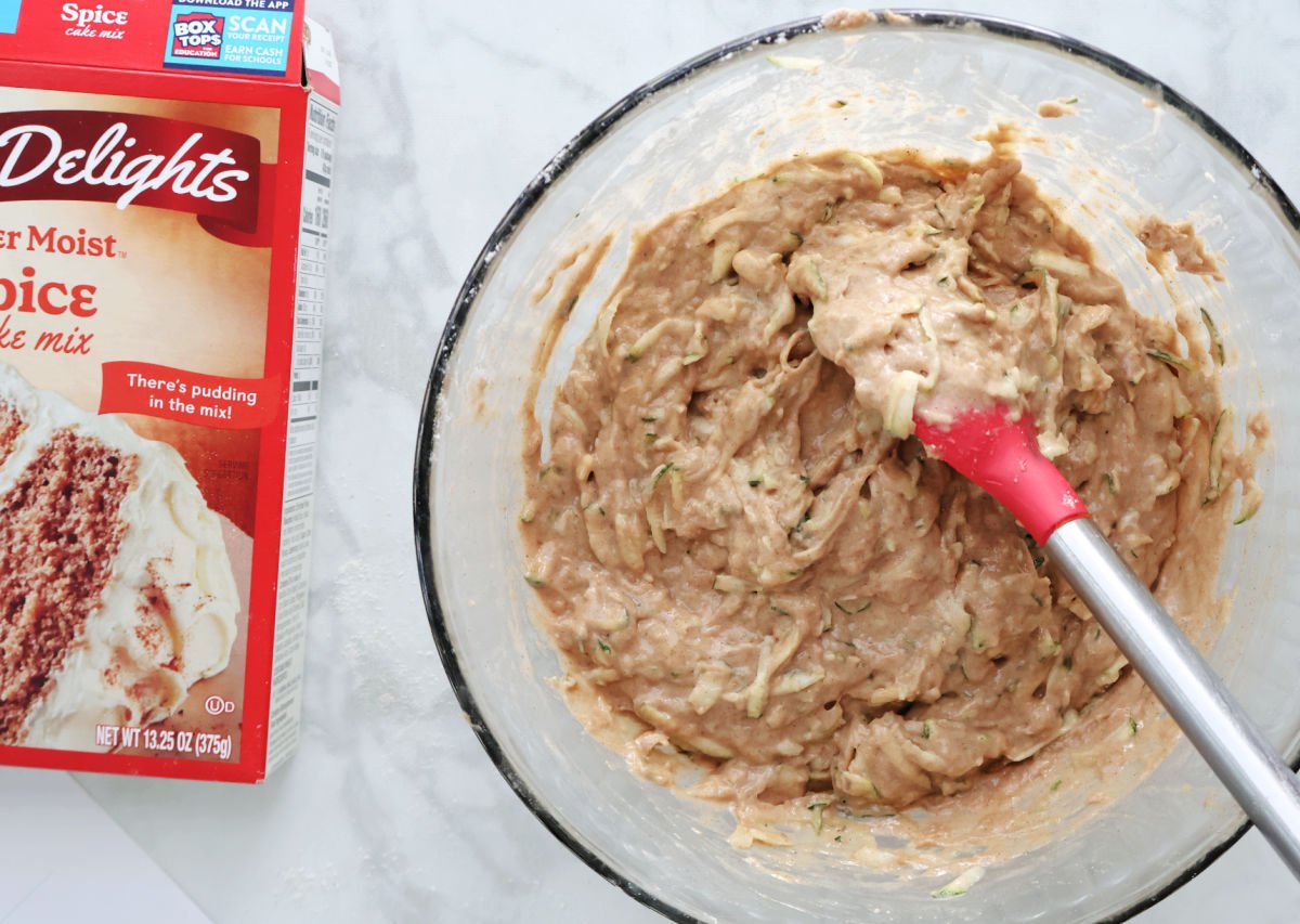 batter made up of shredded zucchini, eggs and cake mix ready to be put into baking dish.
