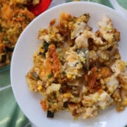 delicious zucchini, chicken and stuffing casserole served up on a white plate.