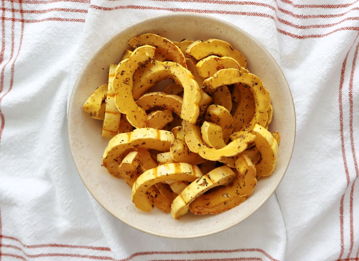 delicata squash slices seasoned with herbs and roasted in the oven.
