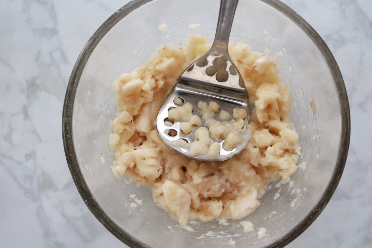 Mashing bananas for homemade banana bread.
