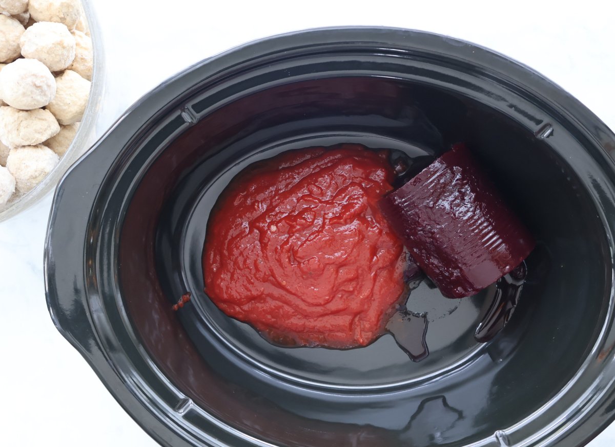 cranberry sauce and heinz chilli saue in crock pot waiting for meatballs.