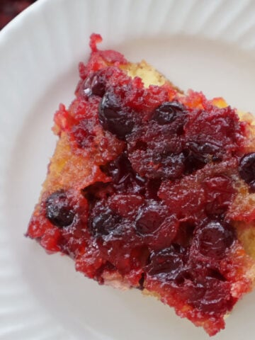 Cranberry orange upside down cake made with cake mix, topped with caramelized cranberries and orange zest.