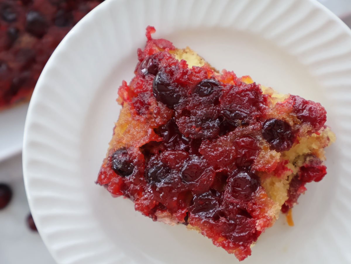 Cranberry orange upside down cake made with cake mix, topped with caramelized cranberries and orange zest.
