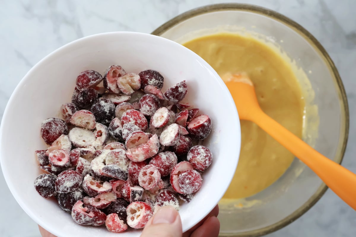 Closeup of chopped cranbarries lightly covered with cake mix.