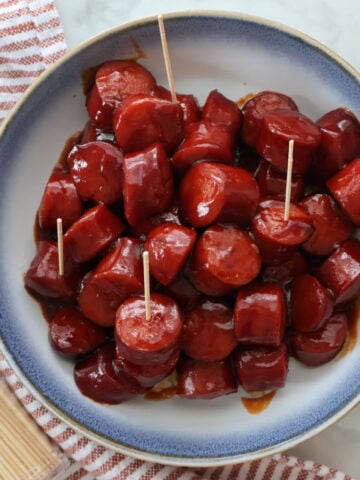 3 ingredient BBQ Kielbasa appetizer in a blue and white bowl.