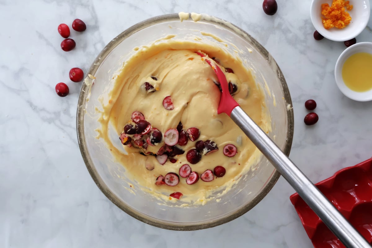 Folding in cranberries into cranberry orange batter. 
