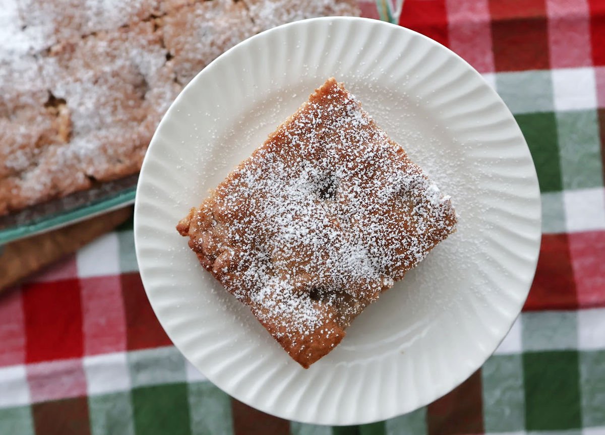 Slice of apple spice cake made with spice cake mix and apple pie filling on a plate.