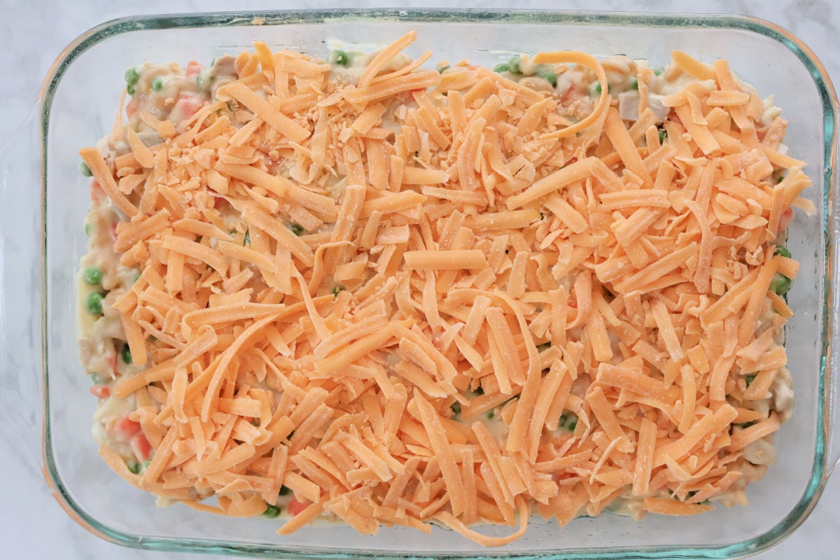 cheese on top of turkey casserole in a glass dish