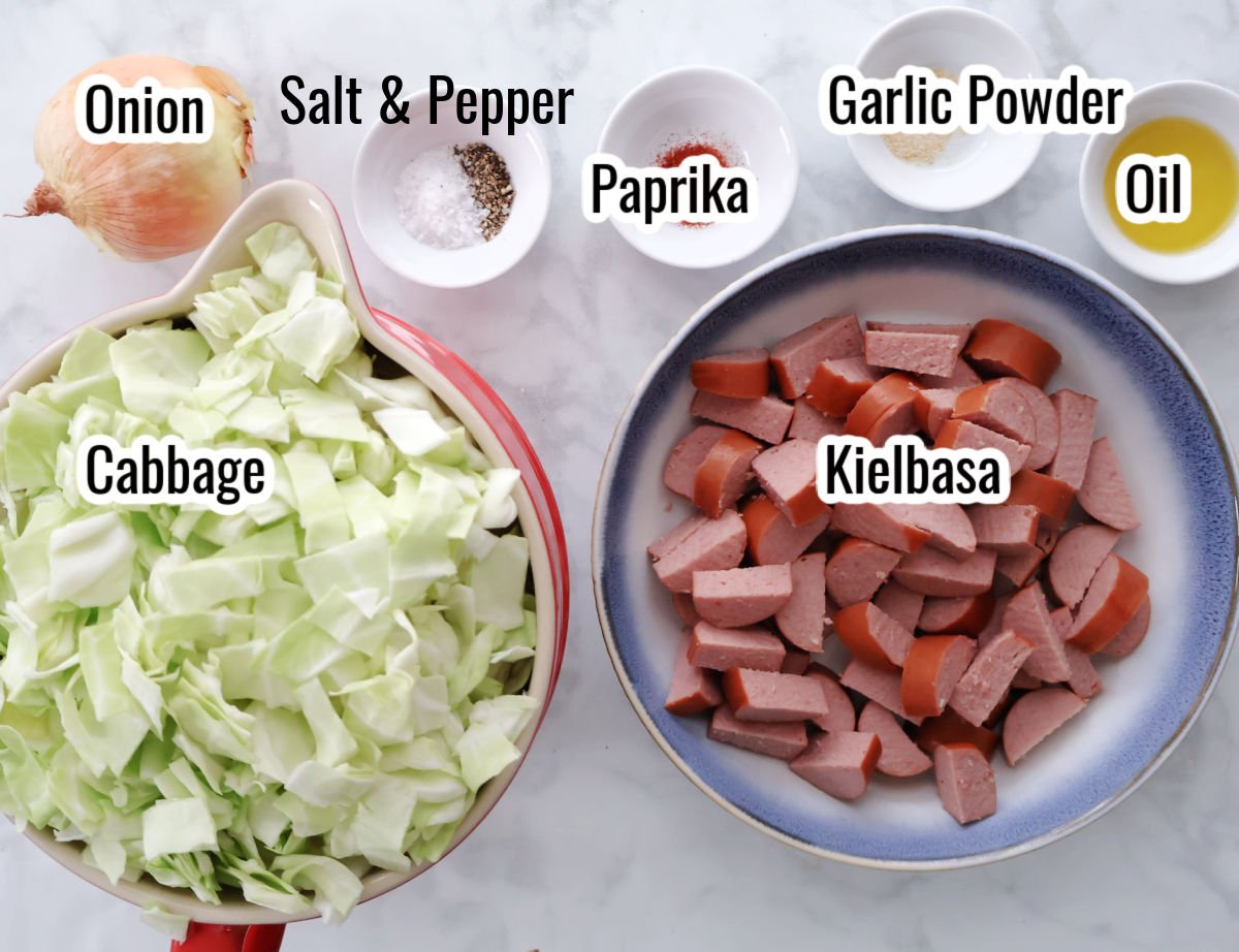 ingredients for smothered cabbage dish includes chopped cabbage, kielbasa, onion, and seasonings.