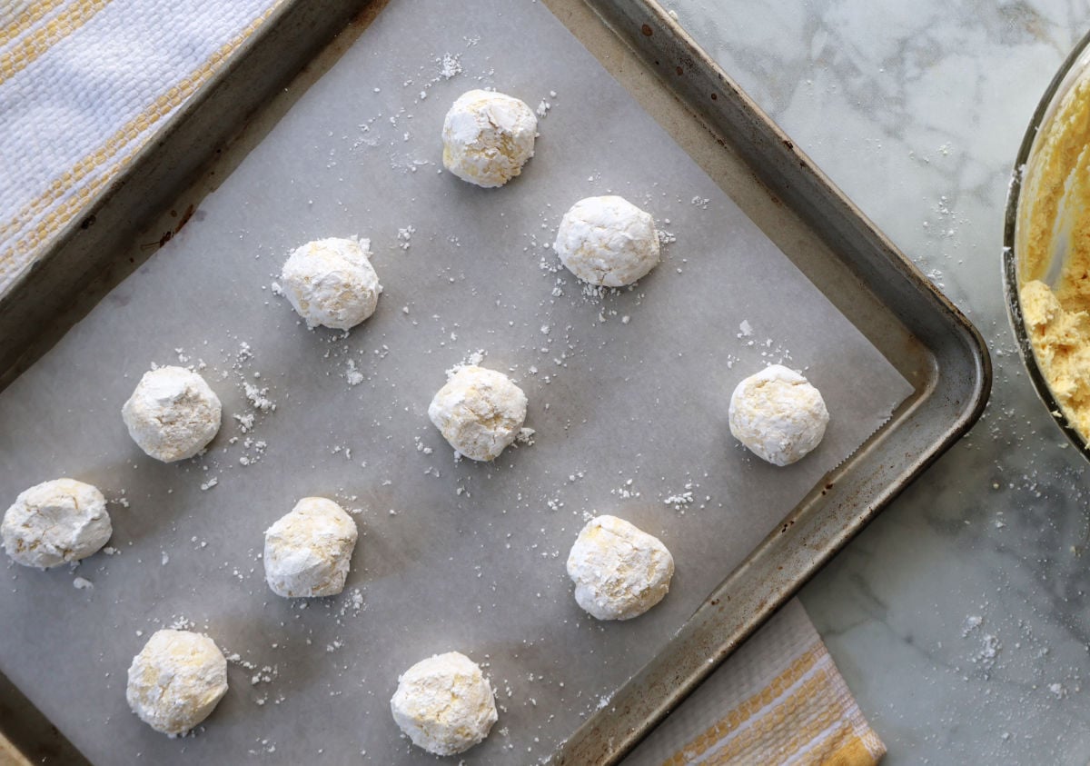 lemon cookie dough balls on a cookie sheet
