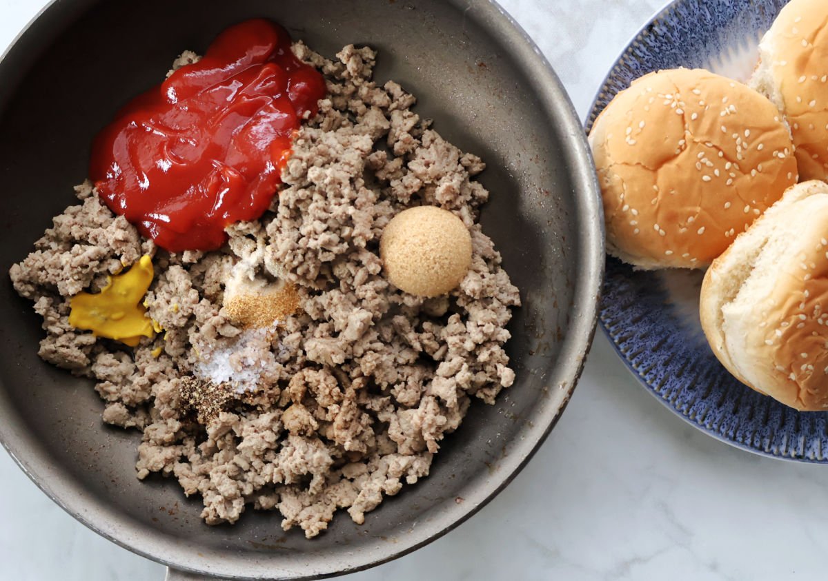Ground turkey browning in a skillet for turkey sloppy joes.