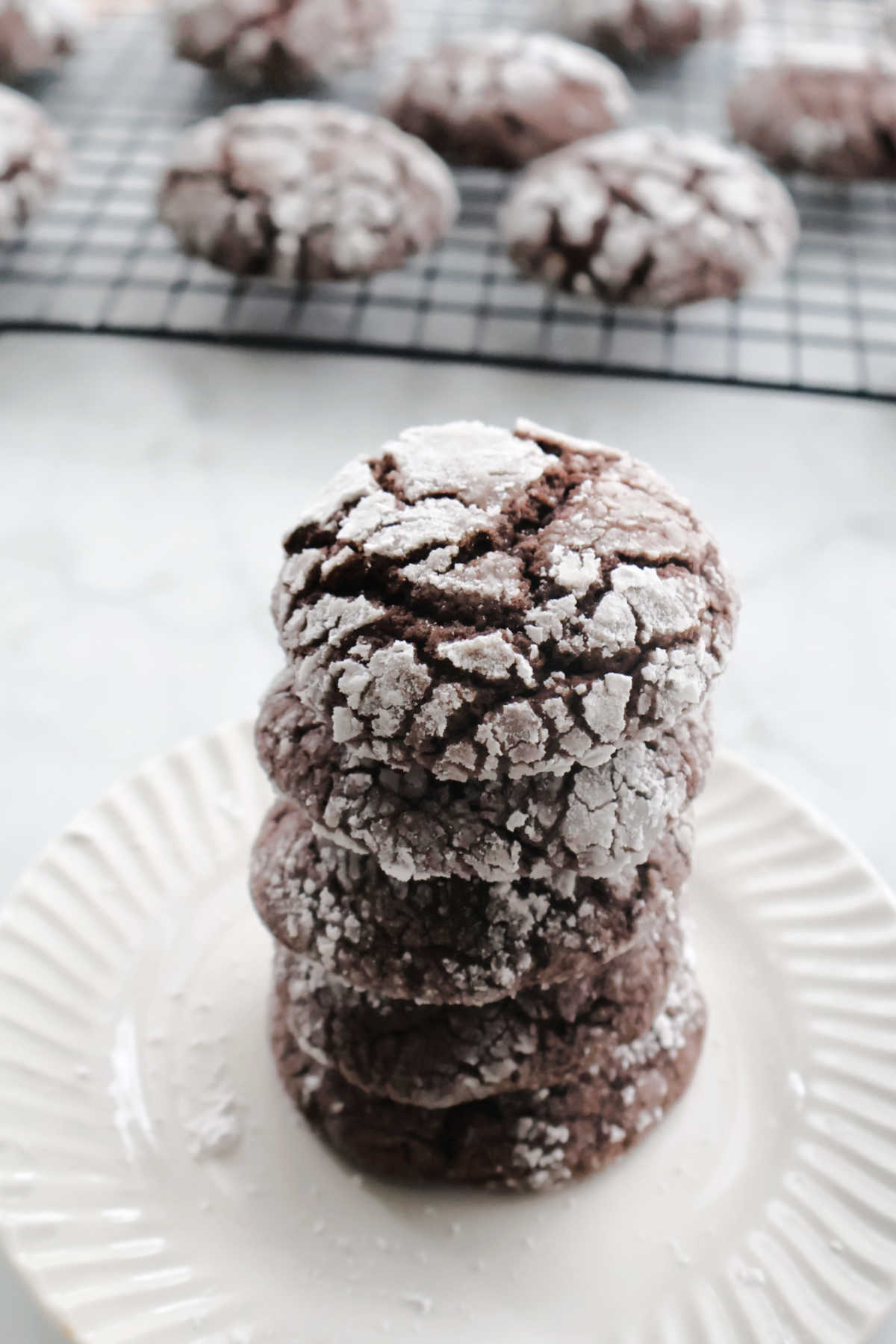 Chocolate crinkle cookies made with cake mix and coated in powdered sugar showing classic crackled tops.