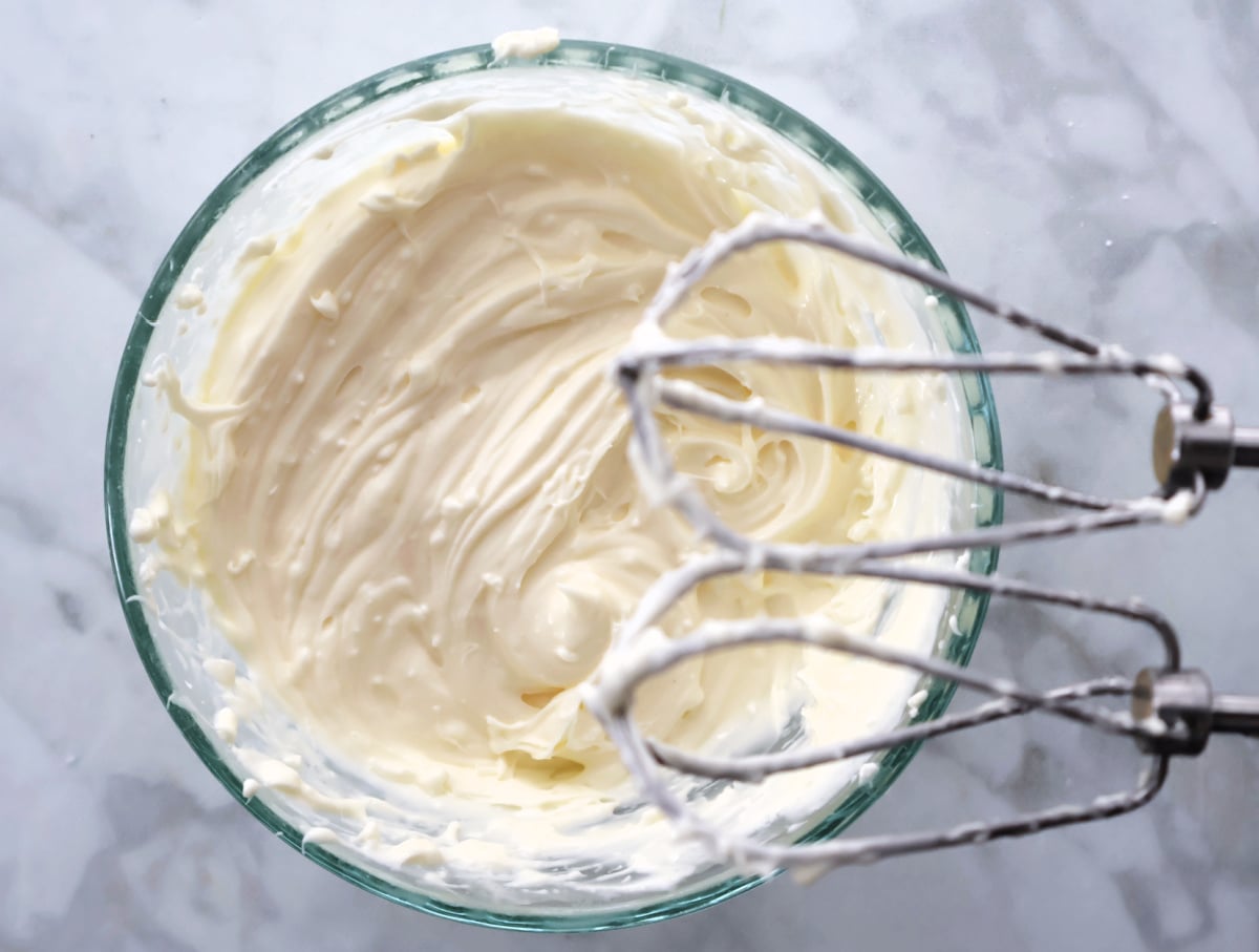 Cream cheese mixture being blended until smooth for dump cake