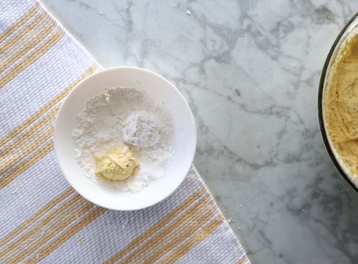 rolling cookies in powdered sugar