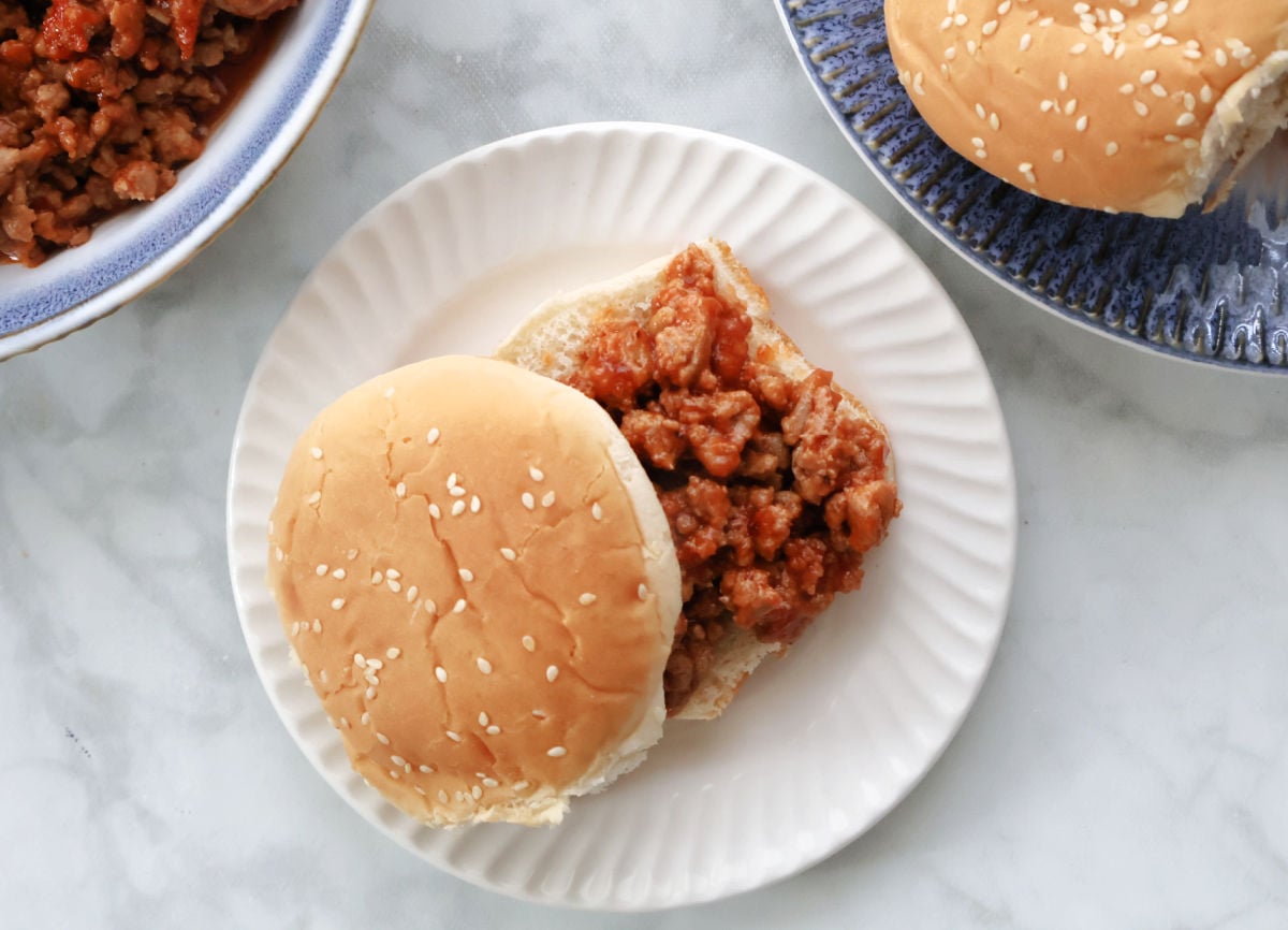 Sloppy Jane sauce mixed into cooked ground turkey in a skillet.