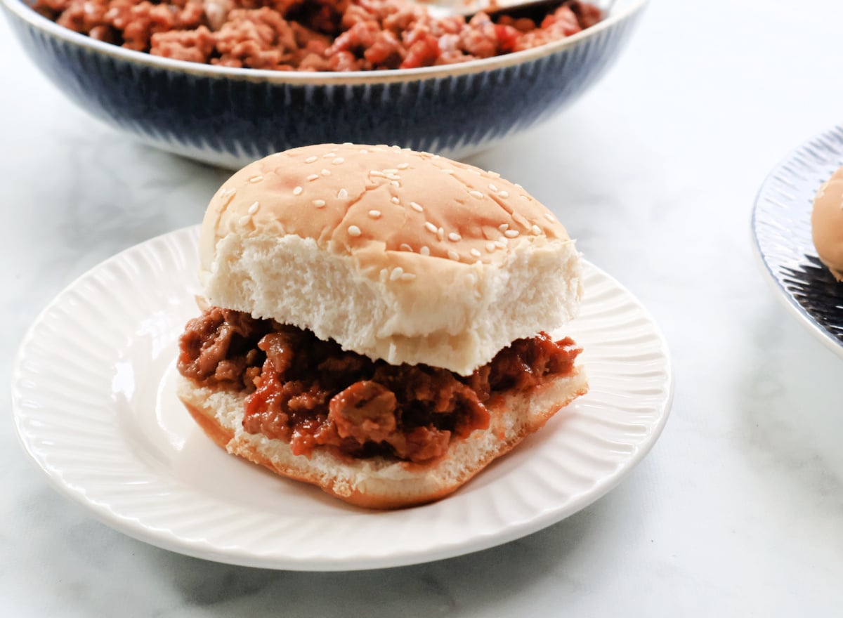 Turkey sloppy joe sandwich on a hamburger bun served on a plate for an easy weeknight dinner.