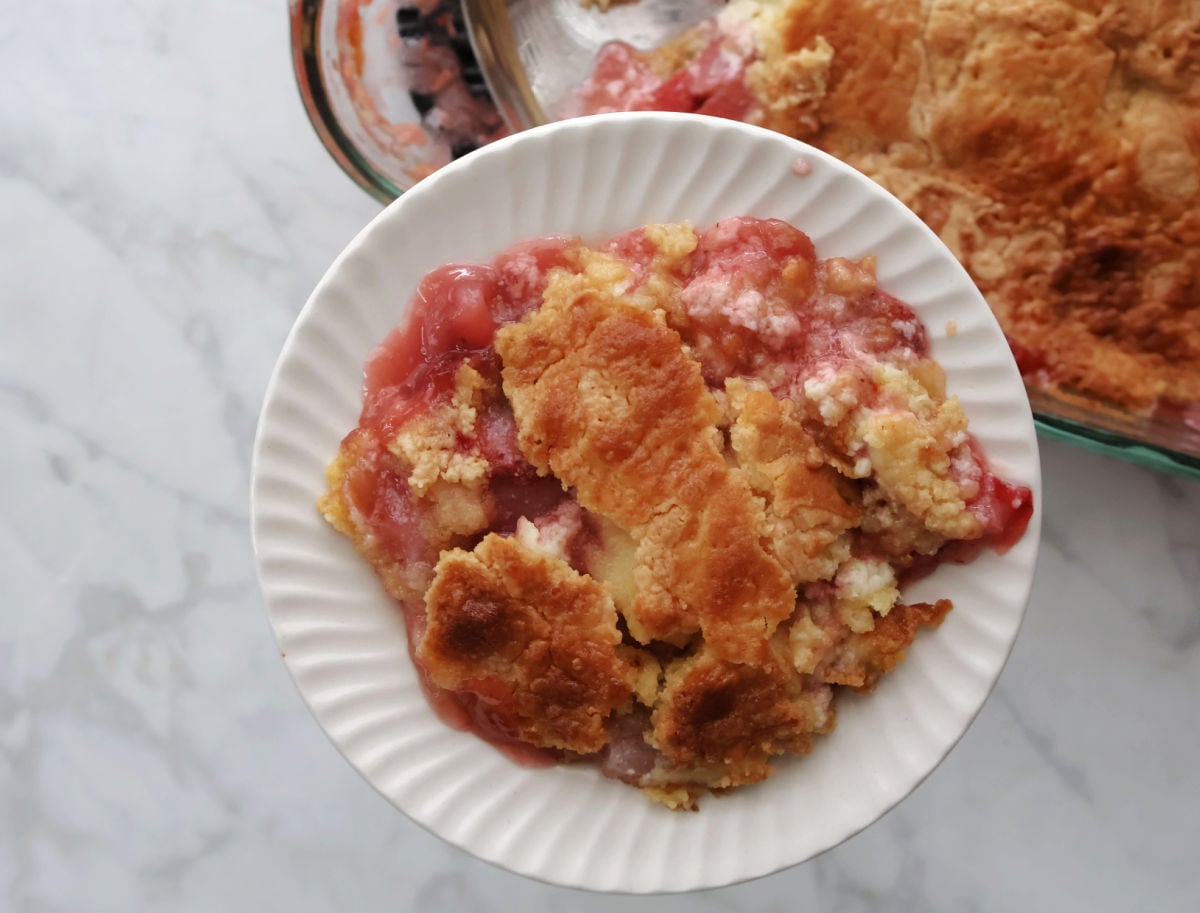 Close-up of strawberry cream cheese dump cake showing juicy fruit and creamy layers