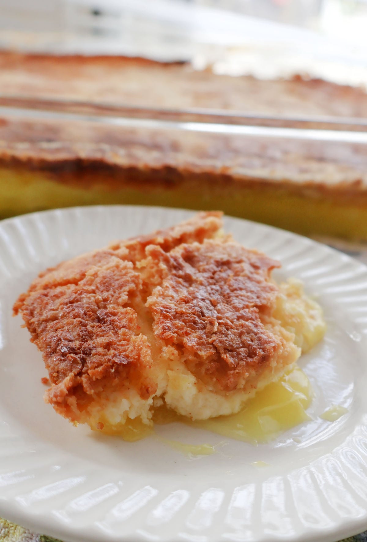 Lemon Cream Cheese Dump cake serving on a white plate.