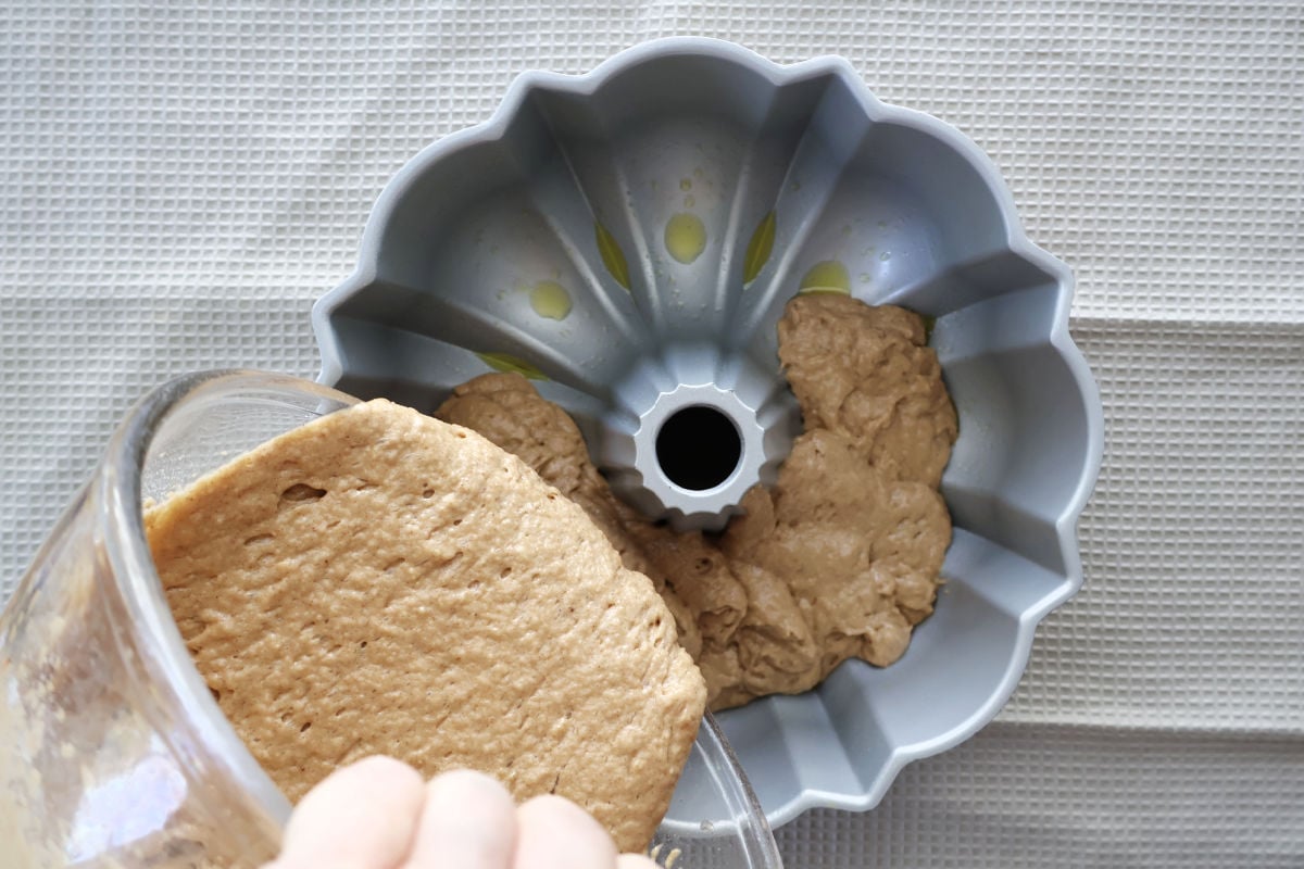 applesauce bundt cake pouring into a bundt pan